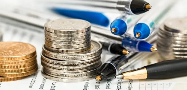 Stacked coins and pens